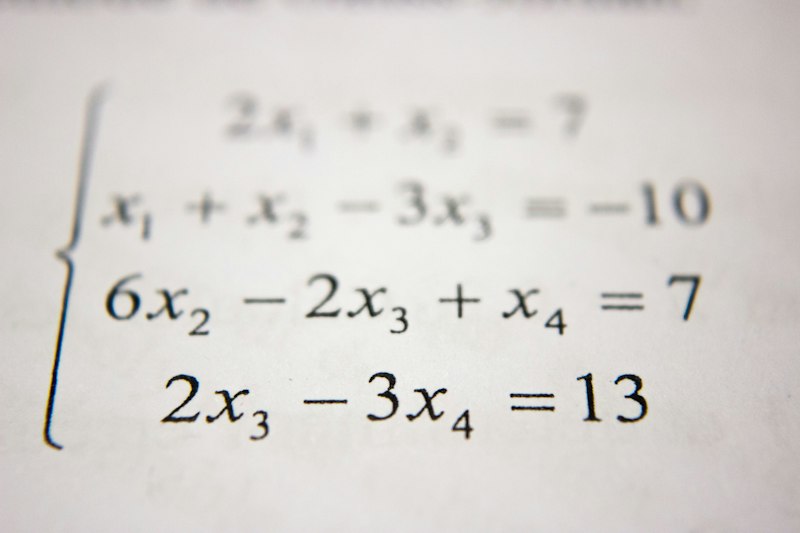 Teacher writing math on chalkboard