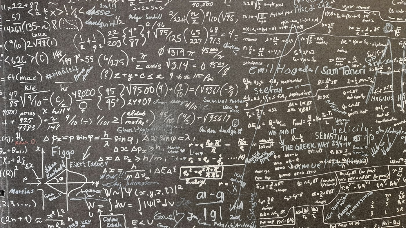 Mathematical formulas covering a dark wall